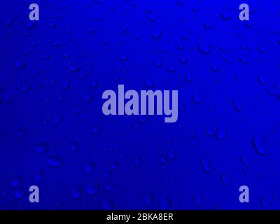 Drops of water on a blue metal surface, beautiful background after rain Stock Photo