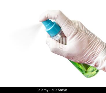 A male hand in a medical glove holds an antiseptic against coronavirus and sprays it into the air. Isolated on a gray background. concept. Stock Photo