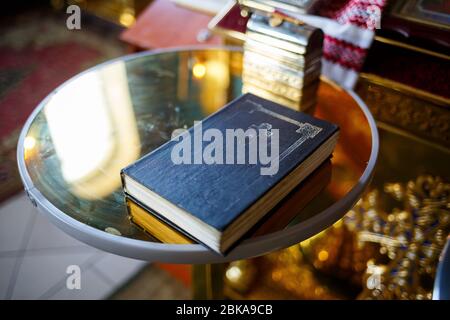 Orthodox religion. Hands of the priest on the bible. Stock Photo