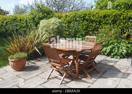 Terrace and wooden garden furniture in a garden during spring Stock Photo