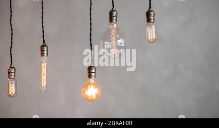 Edison lamp is included in loft room, against background of concrete wall Stock Photo