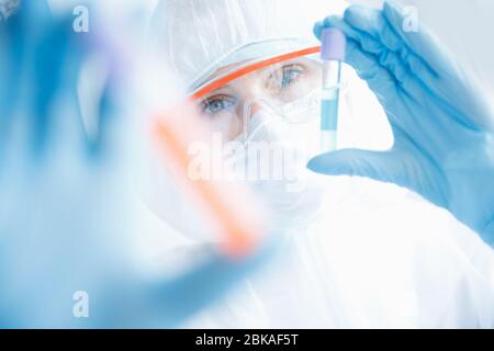 Analysis virus in China and world from coronavirus, doctor in protective chemical suit with respirator computer in laboratory Stock Photo