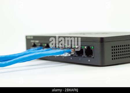 The blue network cables connect port switch on white table concept internet network connection Stock Photo