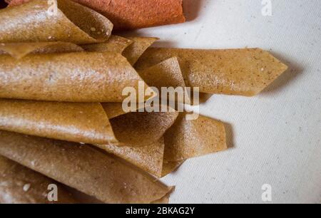Sweet pure fruit pastille. Natural sweets from dried berries and fruits. Useful sweetness is pastille, fruit chips. Dietary vitamin nutrition. Vegan F Stock Photo