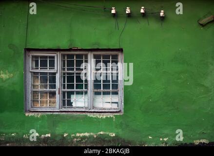 Old damaged windows, grunge window, green wall texture Stock Photo