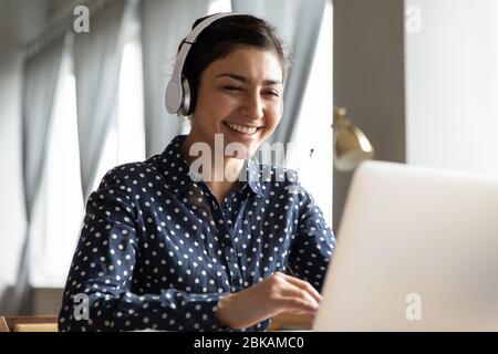 Smiling young indian student attending educational lecture online. Stock Photo