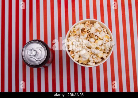 Popcorn bucket box and soda drink on striped background. Stock Photo