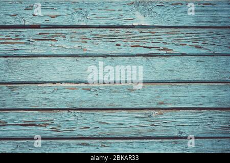 Peeling paint on wooden fence, plank texture, timber background. Old wood painted floor. Desk surface. Natural grunge boards, weathered turquoise tabl Stock Photo