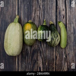 Fresh zucchinis on wood background. Stock Photo