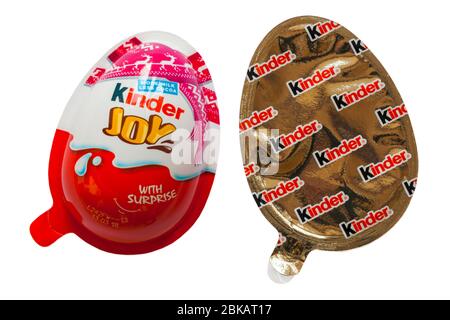 Kinder Joy egg with surprise showing both halves isolated on white background Stock Photo