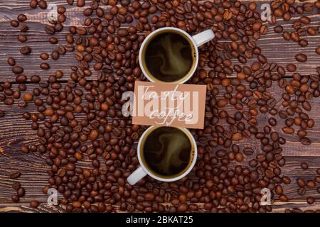 Tasty coffee cups on coffee beans. Stock Photo