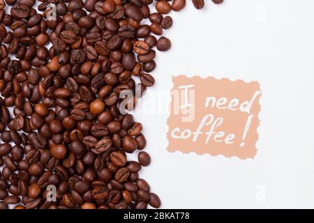 Many coffee beans on white background and message. Stock Photo