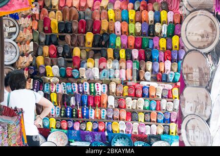 Colourful soft leather sandals on display in the market shops in Marrakech Stock Photo