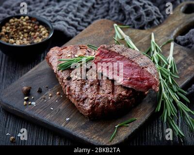 grilled beef fillet steak meat on dark wooden table Stock Photo