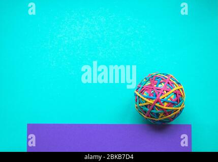 Rubber band ball on colored paper Stock Photo
