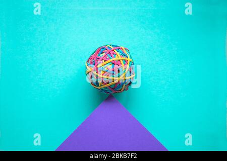 Rubber band ball on colored paper Stock Photo