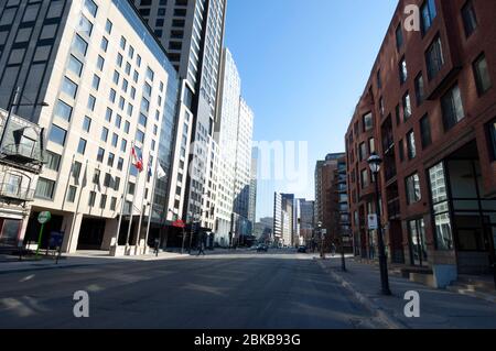 MONTREAL, CANADA - APRIL 28, 2020: During Covid19 lock-down, Rue Sherbrooke clearly shows the impact of the pandemic on the traffic on one of the most Stock Photo