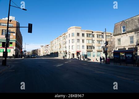 MONTREAL, CANADA - APRIL 28, 2020: During Covid19 lock-down, Rue Sherbrooke clearly shows the impact of the pandemic on the traffic on one of the most Stock Photo