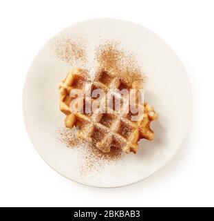 plate of freshly baked belgian waffle with cinnamon isolated on white background, top view Stock Photo