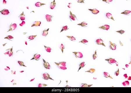 Rose buds on white background. Dry rose buds for tea on isolated background. Herbal tea. Stock Photo