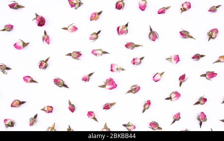 Rose buds on white background. Dry rose buds for tea on isolated background. Herbal tea. Stock Photo