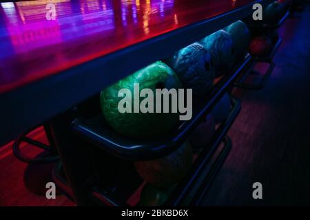 bowling balls under the table on which the light falls, background texture Stock Photo