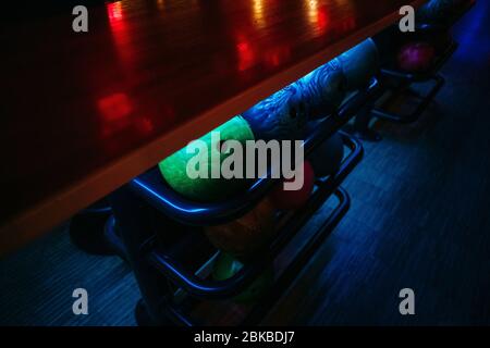 bowling balls under the table on which the light falls, background texture Stock Photo
