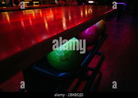 bowling balls under the table on which the light falls, background texture Stock Photo