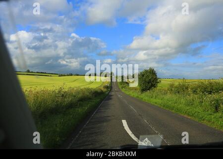 traveling on empty road, early summer rural location, uk Stock Photo