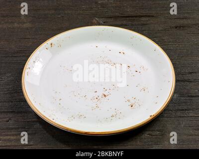 empty plate on dark wooden litchen table Stock Photo