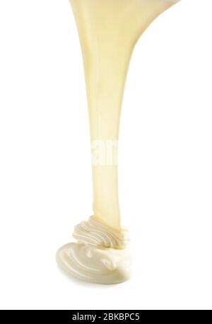 pouring melted white chocolate isolated on white background Stock Photo