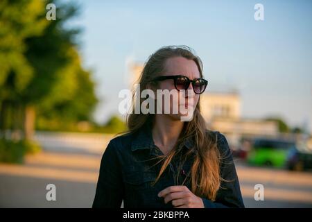 girl wanders along deserted car park Stock Photo