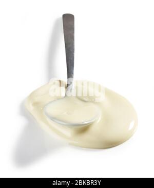 spoon of melted white chocolate isolated on white background Stock Photo