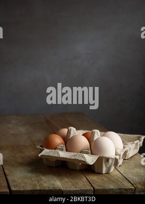 fresh natural organic chicken eggs on old wooden kitchen table Stock Photo