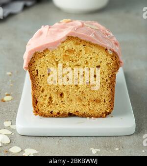 freshly baked sweet bread with pink chocolate on grey table Stock Photo