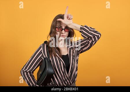 Funny Girl Imitates Unicorn, Holds Finger Above Her Head Like Horn Stock Photo