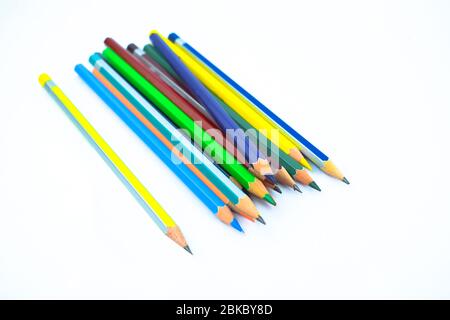 Stack of different colored wood pencil crayons placed on a white isolated background Stock Photo