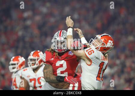 Chase Young, Ohio State defensive end, takes a shot at Trevor Lawrence, Clemson quarterback, during the 2019 College Football Playoff semifinal. Stock Photo