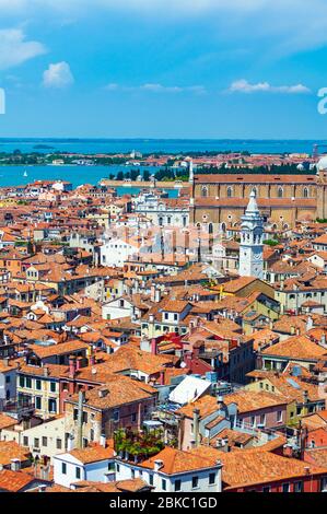 Panoramic aerial view of Venice houses red roofs,Basilica dei Santi Giovanni e Paolo at Castello at the distance,Murano island Stock Photo
