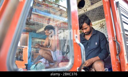 Truck drivers from Uttar Pradesh sit in their truck after getting stuck in Mumbai before delivering industrial materials during the lockdown.Indian Prime Minister, Narendra Modi has announced the extension of the lockdown till 17 may across the country restricting the movement of people to curb the spread of the coronavirus. More than 40206 tested positive for corona virus in India with 1323 deaths. Stock Photo