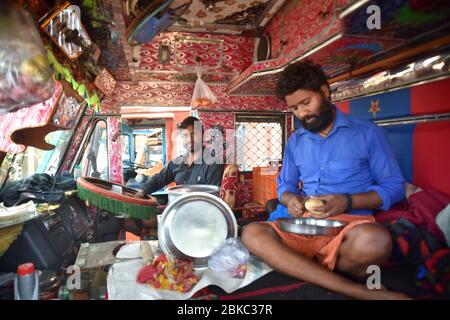 Truck drivers from Uttar Pradesh sit in their truck after getting stuck in Mumbai before delivering industrial materials during the lockdown.Indian Prime Minister, Narendra Modi has announced the extension of the lockdown till 17 may across the country restricting the movement of people to curb the spread of the coronavirus. More than 40206 tested positive for corona virus in India with 1323 deaths. Stock Photo