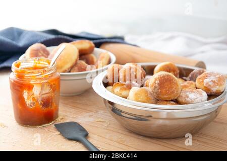 bowl full of homemade sugar donuts with jam Stock Photo