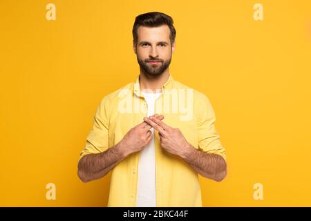Man using deaf and dumb language on yellow background Stock Photo