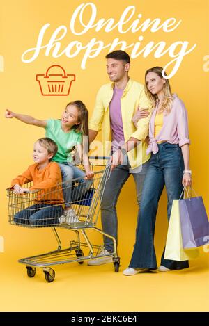 parents with shopping bags and kids gesturing and sitting in shopping cart on yellow, online shopping illustration Stock Photo