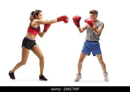 Full length shot of a young guy and woman training boxing isolated on white background Stock Photo