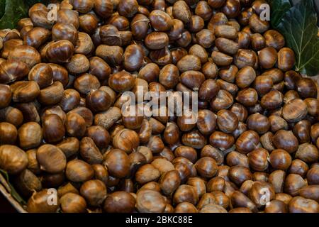 Raw chestnuts for sale in market. Delicious and healthy snacks. Stock Photo