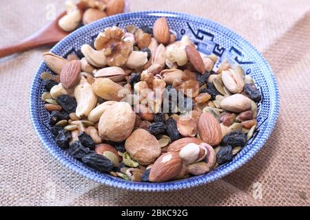 Mixed nuts in a bowls on wooden background . Stock Photo