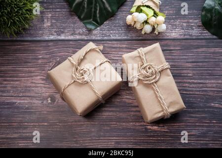 Handmade crafted paper gift boxes on wooden background . Stock Photo
