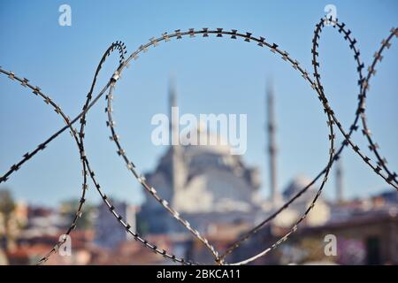 Mosque behind the barbed wire. Conceptual photo about the severe limitations of the Islamic faith Stock Photo