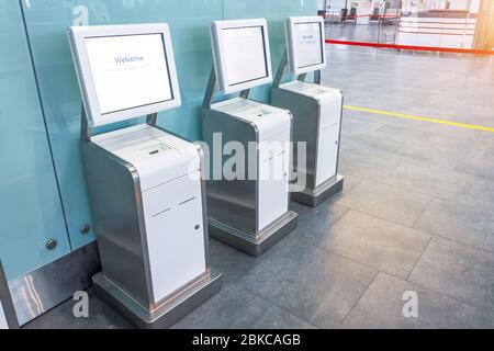 Three self check-in counters for a flight located in the airport passenger terminal, convenience and time saving Stock Photo